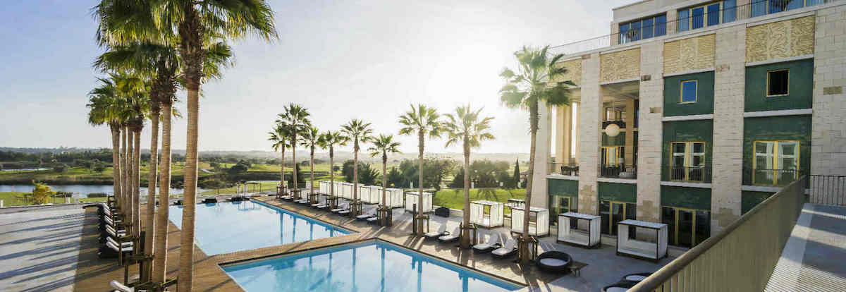 Palms line the pool area at Anantara Vilamoura Algarve Resort</