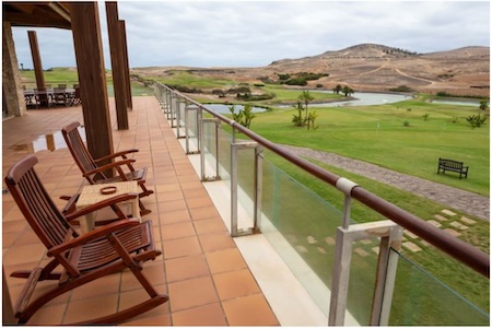 The restaurant terrace overlooks the golf course and the sea