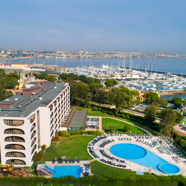 Aerial view of Vila Gale Cascais Hotel including pool and marina in the distance