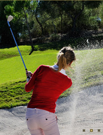Woman golfer hitting from bunker at Las Colinas Golf