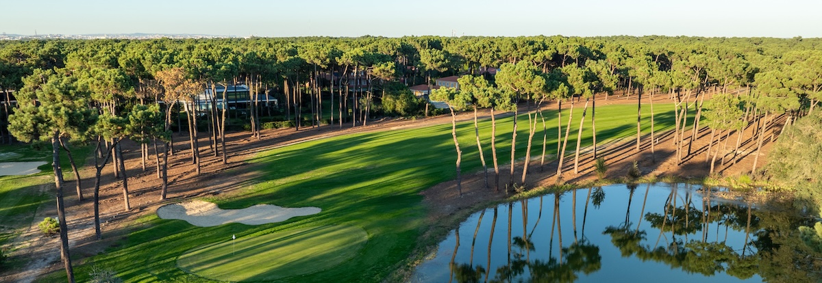 This green on the PGA Aroeira 1 course is guarded by a large bunker and awater hazard.