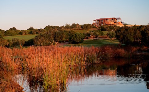 View from water hazard to Espiche Golf's clubhouse