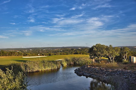 Solar windmills in the distance from Espiche Golf